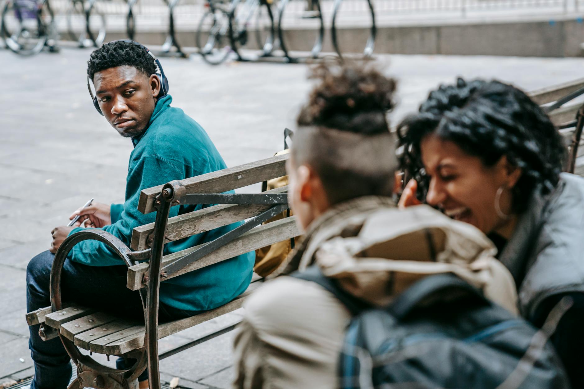 couple of students gossiping and laughing near black man